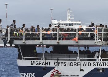Migrants wait to disembark from the Migrant Offshore Aid Station (MOAS) vessel "Phoenix" in the harbor of Messina, Sicily, Southern Italy, Saturday, May 15, 2015. Over 400 migrants, half of them women and children, disembarked in Messina Saturday. (AP Photo/Carmelo Imbesi)