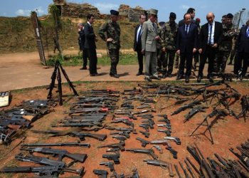 epa04104025 French President Francois Hollande (3-L), French Defense Minister Jean-Yves Le Drian (3-R) and French Foreign Minister Laurent Fabius (L) inspect arms confiscated from ex-Seleka rebels and Anti-balaka militia by the French military of operation Sangaris at a French military base in Bangui in Bangui, Central African Republic, 28 February 2014.  EPA/SIA KAMBOU/POOL MAXPPP OUT