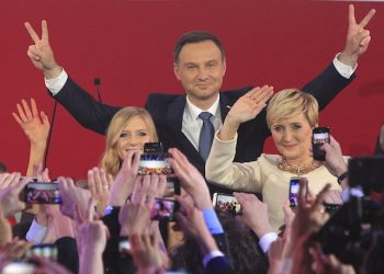 Opposition candidate Andrzej Duda, with wife Agata,right, and daughter Kinga greet supporters as first  exit polls in the presidential runoff voting are announced, showing he won the election in Warsaw, Poland, Sunday, May 24, 2015.Polish President Bronislaw Komorowski conceded defeat in the presidential election Sunday after an exit poll showed him trailing Duda, a previously little-known right-wing politician.(AP Photo/Czarek Sokolowski)