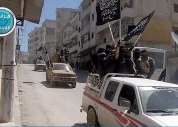 FILE - In this file photo posted on the Twitter page of Syria's al-Qaida-linked Nusra Front on Saturday, April 25, 2015, which is consistent with AP reporting, Nusra Front fighters stand on their vehicles and wave their group's flags as they tour the streets of Jisr al-Shughour, Idlib province, Syria. In Syria, al-Qaida's Nusra Front is the most powerful fighting force outside the territories held by the Islamic State group. Last month, it worked with other rebel factions, including ones backed by Saudi Arabia, Turkey and Qatar, to capture the northwestern city of Idlib and territory in the south _ the biggest victories in several years over President Bashar Assad.  (Al-Nusra Front Twitter page via AP, File)