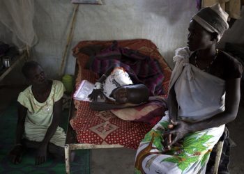 epa04569066 A handout photo made available by the Medecins Sans Frontieres (MSF) on 19 January 2015 shows ten-year-old Chaikok Cha (C), a kala azar patient, is cared for by his family at MSF hospital in Lankien, South Sudan, 14 January 2015. The conflict that erupted in South Sudan little more than a year ago has left people more vulnerable to a deadly tropical kala azar disease, also known as black fever. Last year, MSF treated over 6,700 cases of kala azar in South Sudan, more than double the number of cases it treated the year before (2714 cases treated in 2013). Kala azar is a tropical, parasitic disease transmitted through bites from certain types of sand fly.  EPA/KAREL PRINSLOO / MEDECINS SANS FRONTIERES / HANDOUT  HANDOUT EDITORIAL USE ONLY/NO SALES