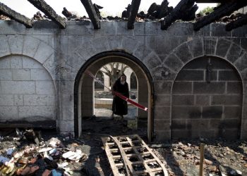 A nun surveys heavy damage at the Church of the Multiplication after a fire broke out in the middle of the night near the Sea of Galilee in Tabgha, Israel, Thursday, June 18, 2015. Israel police spokesman Micky Rosenfeld said police are investigating whether the fire was deliberate and are searching for suspects. A passage from a Jewish prayer, calling for the wiping out of idol worship, was found scrawled in red spray paint on a wall outside the church. (AP Photo/Ariel Schalit)