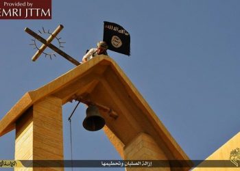 On March 16, 2015, the Islamic State (ISIS) published a collection of images showing an array of acts of vandalism perpetrated against churches in Ninawa, Iraq. The images show ISIS men engaged in the destruction of various Christian symbols, which ISIS perceives as being polytheistic and idolatrous. The men remove crosses from atop churches and replace them with the black ISIS banner, destroy crosses at other locations such as atop doorways and gravestones, and destroy and remove icons and statues inside and outside churches. Ansa/MEMRI's Jihad and Terrorism Threat Monitor (JTTM) ++ No sales, editorial use only ++