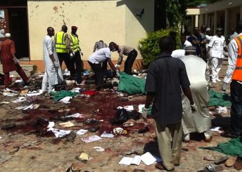 epa04835377 Members of the Jama'atu nasiril Islam first aid group, Red Cross helpers and security agents jointly search the scene for victims after a suicide bomber detonated a bomb at a local government building in the Sabon Gari district of the city of Zaria, Kaduna State, northern Nigeria, 07 July 2015. The suicide bomber reportedly entered a local government building as hundreds of civil servants were undergoing an identity check and detonated a bomb, killing at least 20 people. The blast was the latest in a string of attacks that have claimed more than 200 lives in Africa's largest economy in the past week alone. No group has yet claimed responsibility for the attack, but suspicion has been cast on Boko Haram, an extremist group which has killed more than 14,000 people since 2009 as it seeks to establish an Islamic state in northern Nigeria.  EPA/STRINGER ATTENTION EDITORS: PICTURE CONTAINS GRAPHIC CONTENT * BEST QUALITY AVAILABLE