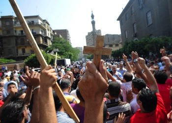 epa02960924 Egyptian Coptic Christians shout slogans and hold crosses, in Abassiya, Cairo, Egypt, 10 October 2011. According to media sources, thousands of protesters gathered on 10 October in central Cairo outside the Coptic Hospital, where they were waiting to receive the bodies of relatives killed in clashes a day earlier between mostly Coptic Christians and government troops. Twenty-six people were killed in violence between troops and demonstrators in front of the state television building late 09 October, and nearly 300 people were wounded.  EPA/MOHAMED OMAR