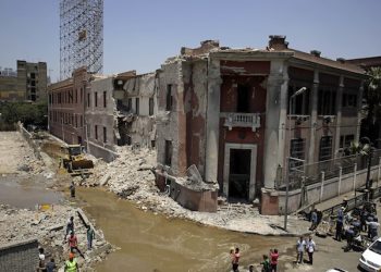 Workers clear rubble at the site of an explosion near the Italian Consulate in downtown, Cairo, Egypt, Saturday, July 11, 2015.  Italy's foreign minister vowed that his country would not be intimidated after a deadly explosion Saturday morning killed one person and heavily damaged the Italian Consulate in the Egyptian capital. (AP Photo/Thomas Hartwell)