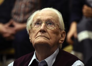 94-year-old former SS sergeant Oskar Groening looks up as he listens to the verdict of his trial Wednesday, July 15, 2015 at a court in Lueneburg, northern Germany. Groening, who served at the Auschwitz death camp was convicted on 300,000 counts of accessory to murder and given a four-year sentence. (Tobias Schwarz/Pool Photo via AP)