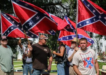 Attendees of a pro-Confederate flag rally hold flags and listen to speakers at the Alabama state capitol building on Saturday, June 27, 2015, in Montgomery, Ala. The rally was held by locals and members of several Southern heritage organizations who oppose the recent removal of Confederate flags from a monument at the capitol honoring Confederate Civil War soldiers. (AP Photo/ Ron Harris)