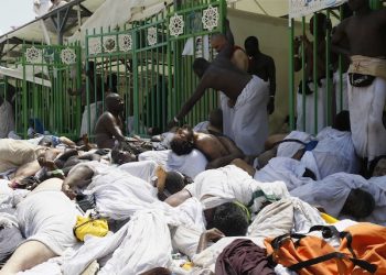 Muslim pilgrims gather around bodies of people crushed in Mina, Saudi Arabia during the annual hajj pilgrimage on Thursday, Sept. 24, 2015. Hundreds were killed and injured, Saudi authorities said. The crush happened in Mina, a large valley about five kilometers (three miles) from the holy city of Mecca that has been the site of hajj stampedes in years past. (AP Photo)
