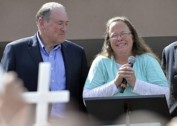 Rowan County Clerk Kim Davis, with Republican presidential candidate Mike Huckabee, left, at her side, speaks after being released from the Carter County Detention Center, Tuesday, Sept. 8, 2015, in Grayson, Ky. Davis, the Kentucky county clerk who was jailed for refusing to issue marriage licenses to gay couples, was released Tuesday after five days behind bars.   (AP Photo/Timothy D. Easley)