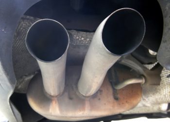The exhaust of a Volkswagen Passat Bluemotion is photographed in Frankfurt, Germany, Thursday, Sept. 24, 2015. The software at the center of Volkswagen's emissions scandal in the U.S. was built into the automaker's cars in Europe as well, though it isn't yet clear if it helped cheat tests as it did in the U.S., Germany said Thursday. A day after longtime CEO Martin Winterkorn stepped down, a member of Volkswagen's supervisory board said that he expects further resignations at the automaker in the wake of the scandal. (AP Photo/Michael Probst)