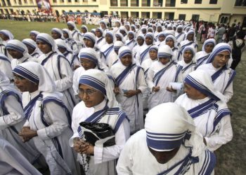 In this Sunday, Nov. 20, 2011, file photo, nuns of Missionaries of Charity, the order founded by Mother Teresa, take part in a procession to mark ''the feast of Christ the King'',a religious holiday celebrated on the last Sunday of the liturgical calendar in Kolkata, India. The Missionaries of Charity, says it has decided to close its adoption services in India after the country amended its rules to allow single parents to adopt. (AP Photo/ Bikas Das)