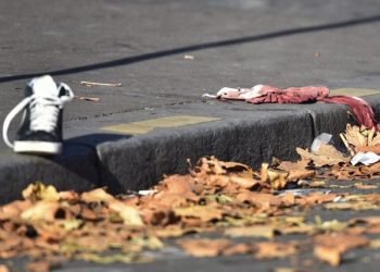 epa05026346 A shoe and a blood-stained cloth lie on the ground near the Bataclan concert venue in Paris, France, 15 November 2015. More than 120 people have been killed in a series of attacks in Paris on 13 November, according to French officials. Eight assailants were killed, seven when they detonated their explosive belts, and one when he was shot by officers, police said. French President Francois Hollande says that the attacks in Paris were an 'act of war' carried out by the Islamic State extremist group.  EPA/UWE ANSPACH