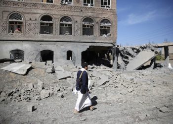 A Shiite fighter, known as a Houthi, walks past of a house damaged by Saudi-led airstrikes in Sanaa, Yemen, Wednesday, Oct. 28, 2015. (AP Photo/Hani Mohammed)
