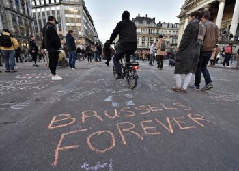 A writing on the asphalt reads "Brussels forever" at the place de la Bourse in the center of Brussels, where people write hundreds of messages on the ground to remember the victims of todays attack, Tuesday, March 22, 2016. Bombs exploded at the Brussels airport and one of the city's metro stations Tuesday, killing and wounding scores of people, as a European capital was again locked down amid heightened security threats. (AP Photo/Martin Meissner)