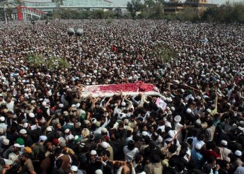 Thousands of people move with an ambulance carrying the body of police officer Mumtaz Qadri, the convicted killer of a former governor, during funeral prayers, in Rawalpindi, Pakistan, Tuesday, March 1, 2016. Tens of thousands of Pakistanis converged Tuesday on a city near the country's capital to attend the funeral of Qadri who was executed Monday for assassinating the secular governor in 2011 over accusations of blasphemy. (AP Photo/Anjum Naveed)