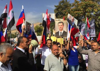 epa04975733 Hundreds of Syrians gather in front of the Russian embassy in Damascus, Syria on 13 October 2015 to express gratitude for Russia for its recent military intervention in Syria that aimed to eradicate the Islamic State and other 'terrorist groups'. The demonstrators carried photos of Russian and Syrian presidents, Vladimir Putin and Bashar Assad, and waved the Russian and Syrian flags. Panic was caused in the capital during the morning rush hour when apparent Syrian rebel fired shells that landed near the Russian embassy, a witness in the area told German news agency dpa. Pro-Syrian media in Lebanon said the attack took place as people were gathering in the area to stage a demonstration to support the Russian intervention in Syria, which is aimed at backing the government of President Bashar al-Assad, especially in centre and north.  EPA/STR