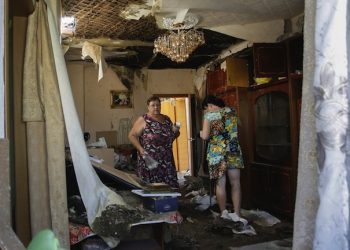 epaselect epa04869791 Local people react as they return to home that was damaged during a shelling, in Donetsk, Ukraine, 02 August 2015. Ukraine is fighting two wars, one against Russian-backed separatists and another to reform its government and economy, US Ambassador Geoffrey Pyatt said on 28 July 2015. The rebellion in Ukraine's two eastern-most regions of Donetsk and Luhansk broke out last 2014 shortly after Ukraine's former pro-Russian president was ousted amid protests in Kiev calling for closer ties with the European Union. More than 6,500 people have died in the conflict, according to estimates by the United Nations.  EPA/ALEXANDER ERMOCHENKO