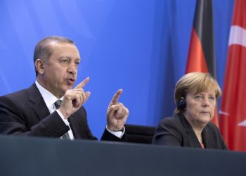 German Chancellor Angela Merkel, right,  listens  as Turkey's Prime Minister Recep Tayyip Erdogan, left,  speaks  during a joint press conference after a meeting at the chancellery in Berlin, Germany, Tuesday, Feb. 4, 2014.  (AP Photo/Axel Schmidt)