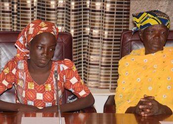 Amina Ali, left, the rescued Chibok school girl, and her mother attend a meeting with Nigeria's President Muhammadu Buhari at the Presidential palace in Abuja, Nigeria, Thursday, May. 19, 2016. The first Chibok teenager to escape from Boko Haram's Sambisa Forest stronghold was flown to Abuja on Thursday and met with Nigeria's president, even as her freedom adds pressure on the government to do more to rescue 218 other missing girls. (AP Photo/Azeez Akunleyan)