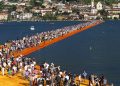 People walk the 'The Floating Piers' by  Bulgarian artists Christo and Jeanne-Claude on Lake Iseo during the opening of the art work near Sulzano, northern Italy, 18 June 2016. The 'Floating Piers' with their bright orange covers will be open until 03 July and will connect the two towns Sulzano and Monte Isola. 
ANSA/FILIPPO VENEZIA