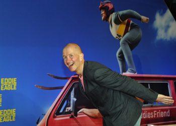 epa05223181 British ski jumper Eddie 'The Eagle' Edwards poses as he arrives for a special screening of 'Eddie The Eagle' in Munich, Germany, 20 March 2016.  EPA/URSULA DUEREN