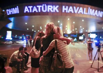 Passengers embrace each other on the entrance to Istanbul's Ataturk airport, early Wednesday, June 29, 2016 following its evacuation after a blast. Two explosions have rocked Istanbul's Ataturk airport Tuesday, killing several people and wounding scores of others, Turkey's justice minister and another official said. A Turkish official says two attackers have blown themselves up at the airport after police fire at them. Turkish authorities have banned distribution of images relating to the Ataturk airport attack within Turkey. (AP Photo/Emrah Gurel) TURKEY OUT