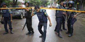 Bangladeshi policemen stand guard in an area cordoned off after heavily armed militants struck at the heart of Bangladesh's diplomatic zone on Friday night, in Dhaka, Bangladesh, Saturday, July 2, 2016. Bangladeshi forces stormed the popular Holey Artisan Bakery in Dhaka's Gulshan area to end a hostage-taking early Saturday. (AP Photo)