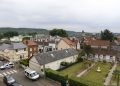 General view of the town of Saint-Etienne-du-Rouvray, Normandy, France, where a 84-year-old priest was murdered in a church, in background, during an attack, Tuesday, July 26, 2016. Two attackers invaded a church Tuesday during morning Mass near the Normandy city of Rouen, killing an 84-year-old priest by slitting his throat and taking hostages before being shot and killed by police, French officials said. (AP Photo/Francois Mori)