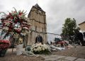 A wreath of flowers from Muslim of France Associations is placed with flowers next to the church where an hostage taking left a priest dead the day before in Saint-Etienne-du-Rouvray, Normandy, France, Wednesday, July 27, 2016. The Islamic State group crossed a new threshold Tuesday in its war against the West, as two of its followers targeted a church in Normandy, slitting the throat of an elderly priest celebrating Mass and using hostages as human shields before being shot by police. (AP Photo/Francois Mori)