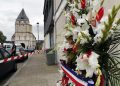 A wreath of flowers from the Muslims of France Association is placed outside the church where a hostage taking left a priest dead the day before, in Saint-Etienne-du-Rouvray, Normandy, France, Wednesday, July 27, 2016. The Islamic State group crossed a new threshold Tuesday in its war against the West, as two of its followers targeted a church in Normandy, slitting the throat of an elderly priest celebrating Mass and using hostages as human shields before being shot by police. (AP Photo/Francois Mori)