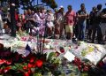 epa05426108 People gather in front of the memorial set on the 'Promenade des Anglais' where the truck crashed into the crowd during the Bastille Day celebrations, in Nice, France, 15 July 2016. According to reports, at least 84 people died and many were wounded after a truck drove into the crowd on the famous Promenade des Anglais during celebrations of Bastille Day in Nice, late 14 July. Anti-terrorism police took over the investigation in the incident, media added.  EPA/IAN LANGSDON