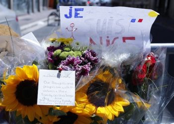 Flowers are pictured near the scene where a truck mowed through revelers in Nice, southern France, Friday, July 15, 2016.  A large truck mowed through revelers gathered for Bastille Day fireworks in Nice, killing more than 80 people and sending people fleeing into the sea as it bore down for more than a mile along the Riviera city's famed waterfront promenade.  (AP Photo/Francois Mori)