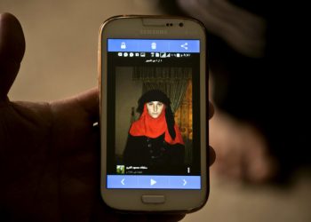 In this Wednesday, May 18, 2016 photo shows a phone image released by Islamic State militants of Nazdar Mahmoud, a 17-year-old Yazidi at Kankhe Camp for the internally displaced in Dahuk, northern Iraq. (AP Photo/Maya Alleruzzo)