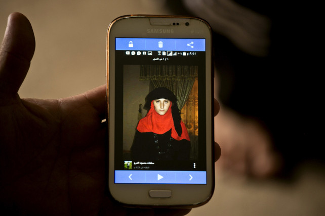 In this Wednesday, May 18, 2016 photo shows a phone image released by Islamic State militants of Nazdar Mahmoud, a 17-year-old Yazidi at Kankhe Camp for the internally displaced in Dahuk, northern Iraq. (AP Photo/Maya Alleruzzo)