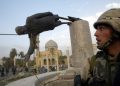 A U.S. soldier watches as a statue of Iraq's President Saddam Hussein falls in central Baghdad April 9, 2003. U.S. troops pulled down a 20-foot (six metre) high statue of President Saddam Hussein in central Baghdad on Wednesday and Iraqis danced on it in contempt for the man who ruled them with an iron grip for 24 years. In scenes reminiscent of the fall of the Berlin Wall in 1989, Iraqis earlier took a sledgehammer to the marble plinth under the statue of Saddam. Youths had placed a noose around the statue's neck and attached the rope to a U.S. armoured recovery vehicle.      REUTERS/Goran Tomasevic