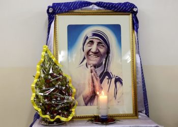A portrait of late Mother Teresa is placed near her tomb at the Missionaries of Charity Mother house in Kolkata, India, Aug. 26, 2016. Mother Teresa will be made a saint on Sept. 4. Born Agnes Gonxha Bojaxhiu on Aug. 26, 1910, in Skopje, Macedonia, Mother Teresa joined the Loreto order of nuns in 1928. In 1946, while traveling by train from Calcutta to Darjeeling, she was inspired to found the Missionaries of Charity order. (AP Photo/Bikas Das)