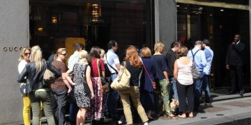 Alcune persone in coda per entrare nella boutique Gucci in via Montenapoleone a Milano, 5 luglio 2014, prima giornata di saldi.
ANSA / MATTEO BAZZI