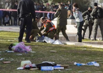 Israeli police and army personnel go through the belongings (in foreground) of Israeli soldiers near to the truck (L, but unseen) that rammed into a group of army soldiers killing in Jerusalem, 08 January 2017. Four Israeli soldiers were killed and another 15 wounded in the attack carried out by a Palestinian who had been released from Israeli jail. The driver of the truck, reported by local media to be an Arab Israeli from East Jerusalem, was shot and killed by security forces, media reports said.  ANSA/JIM HOLLANDER