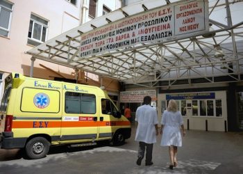 epa03400778 Doctors walk underneath a banner with anti-austerity measures, at the entrance of 'Laiko' Hospital, Athens, Greece, 17 September 2012. Courtrooms, hospitals and universities in Greece remained shut 17 September, in the latest industrial action targeting a new package of austerity measures demanded by the country's international lenders. More than 22,000 public sector doctors began an open-ended strike over unpaid overtime pay, saying they would only treat emergency cases. University professors and judges also began a strike until the end of the month to protest wage cuts.  EPA/FOTIS PLEGAS G.