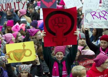 Women with bright pink hats and signs gather early and are set to make their voices heard on the first full day of Donald Trump's presidency, Saturday, Jan. 21, 2017 in Washington.  Organizers of the Women's March on Washington expect more than 200,000 people to attend the gathering.  Other protests are expected in other U.S. cities.  ( AP Photo/Jose Luis Magana)