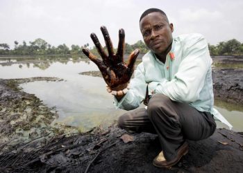 epa03556207 A undated image showing plaintiff Nigerian farmer Eric Dooh showing his hand covered with oil from a creek near Goi, Ogoniland, Nigeria. According to a report of UNEP (United Nations Environment Programme), leaks in Shell pipelines in Nigeria occur regularly, causing harm to communities in the Niger Delta region. A group of Nigerian plaintiffs claim Shell is liable for the damage the leaks caused, while Shell claims most leaks are the result of sabotage. Reports also state fishponds and farmland have been destroyed, while most locals have no other option but to drink from polluted water. Eric Dooh from Goi (Ogoniland), Alali Efanga from Oruma (Bayelsa) and Friday Alfred Akpan from Ikot Ada Udo (Akwa Ibom), individual farmers from three different communities in the Niger Delta, have taken Shell into the Dutch civil court of The Hague in a landmark pollution case, asking for compensation for damages to their land. The verdict in the case is due 30 January 2013.  EPA/MARTEN VAN DIJL