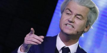 Right-wing populist leader Geert Wilders gestures during a national televised debate with Dutch Prime Minister Mark Rutte, the first head-to-head meeting of the two political party leaders since the start of the election campaign, at Erasmus University in Rotterdam, Netherlands, Monday, March 13, 2017. 
(Yves Herman POOL via AP)