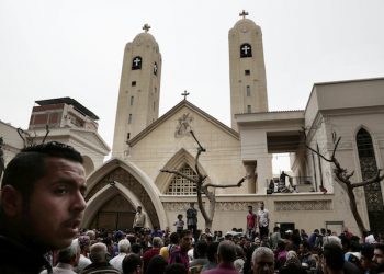 People gather outside the St. George's Church after a suicide bombing, in the Nile Delta town of Tanta, Egypt, Sunday, April 9, 2017. Bombs exploded at two Coptic churches in the northern Egyptian cities of Tanta and Alexandria as worshippers were celebrating Palm Sunday, killing over 40 people and wounding scores more in assaults claimed by the Islamic State group. (AP Photo/Nariman El-Mofty)