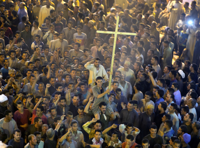 Coptic Christians shout slogans after funeral service at Abu Garnous Cathedral in Minya, Egypt, Friday, May 26, 2017. Egyptian officials say dozens of people were killed and wounded in an attack by masked militants on a bus carrying Coptic Christians, including children, south of Cairo.(AP Photo/Amr Nabil)