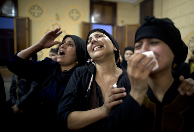 Relatives of killed Coptic Christians grieve during their funeral at Abu Garnous Cathedral in Minya, Egypt, Friday, May 26, 2017. Egyptian officials say dozens of people were killed and wounded in an attack by masked militants on a bus carrying Coptic Christians, including children, south of Cairo.(AP Photo/Amr Nabil)
