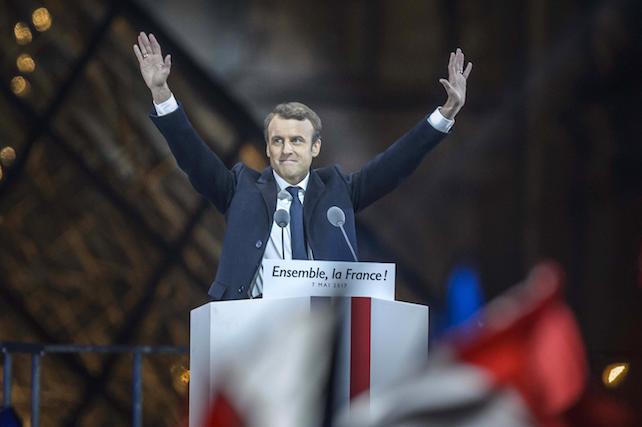 epa05949466 French presidential election candidate for the 'En Marche!' (Onwards!) political movement, Emmanuel Macron celebrates on stage after winning the second round of the French presidential elections at the Carrousel du Louvre in Paris, France, 07 May 2017. Emmanuel Macron defeated Marine Le  Pen in the final round of France's presidential election, with exit polls indicating that Macron is leading with approximately 65.5 per cent of the vote.  EPA/CHRISTOPHE PETIT TESSON