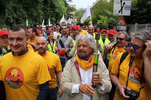Italian Five Stars Movement's leader Beppe Grillo holding a torch in his hands during the second march for the citizenship income organized on Saturday by the party from Perugia to Assisi, central Italy, 20 May 2017. ANSA/ TOMMASO CROCCHIONI