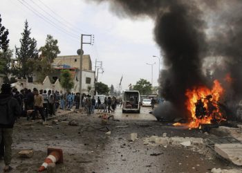 This photo provided by Azaz Media Office, a Syrian anti-government activist group, which has been authenticated based on its contents and other AP reporting, shows Syrian citizens and civil defense workers gathering next of burning car at the explosion scene, in Azaz town, north Syria, Wednesday, May 3, 2017. Syrian activists say a large explosion in a northern town along the border with Turkey has killed and wounded several people. (Azaz Media Office via AP)