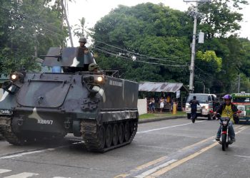 A tank stops on the side of the road as it waits for other tanks to roll into a military camp in Iligan city to reinforce Government troops who are battling Muslim militants who laid siege in Marawi city for over a week now Wednesday, May 31, 2017 in southern Philippines. Fighting continues for the second week now between Government troops and Muslim militants with casualties on both side and civilians.(AP Photo/Bullit Marquez)